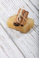 handmade soap with cinnamon on wooden background