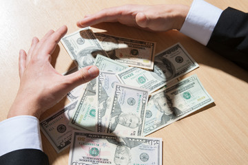 Unrecognizable businessman holding paper money/dollars