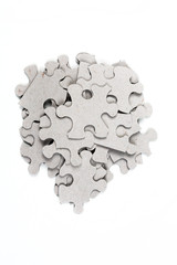 Pile of puzzle pieces isolated on white background