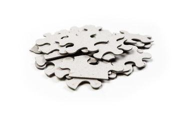 Pile of puzzle pieces isolated on white background