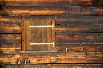 closed window shutter on a sunburned cabin