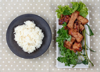 Grilled pork with mixed herb served sticky rice .