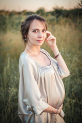 Portrait of a pregnant woman on the nature