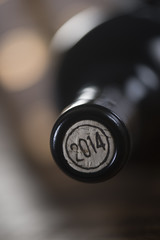 Close-up of closed wine bottles lying on blurry background