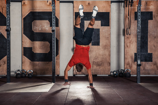 Athlete walking on his hands standing upside down