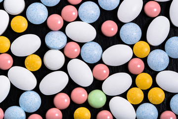 Colorful medicines. Pills, tablets on black background, top view