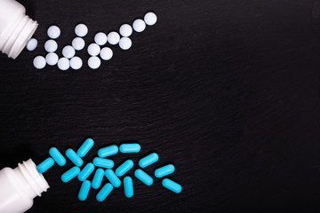 Fototapeta na wymiar Blue pills in a bottle, medicines painkiller. Medications drugs, tablets.