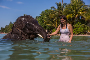 Girl swims with the elephant