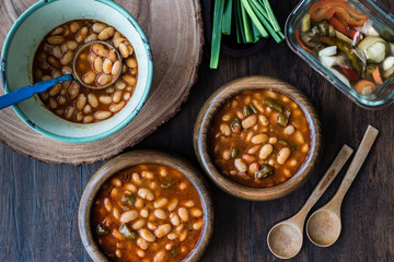 Turkish Kuru Fasulye / Baked Beans in a wooden bowl.