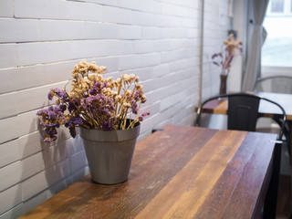 dried flowers in flowerpot on wooden table