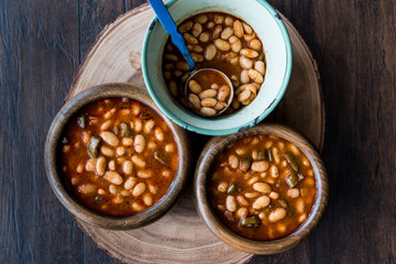 Turkish Kuru Fasulye / Baked Beans in a wooden bowl.