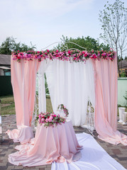 beautiful pink and white arch for wedding ceremony