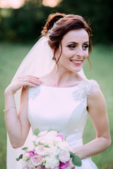 nice portrait of happy and beautiful bride in white dress