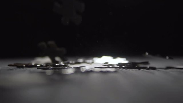 a indoor shot of falling parts of puzzle game on blue wooden table, 100FPS slowmotion