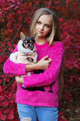 Pretty blonde girl with chihuahua on the nature