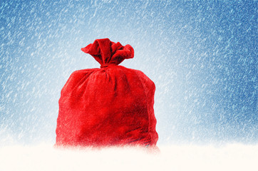 Santa Claus red bag full, on snow background. 