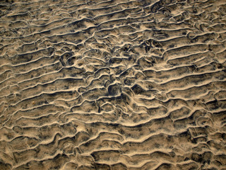 closeup of sand pattern of a beach in the summer