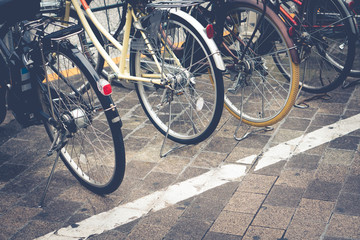 Fototapeta na wymiar Bicycles parking in the big city. Natural light, selective focus