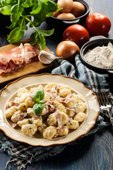 Potato gnocchi, Italian potato dumplings with cheese sauce, ham