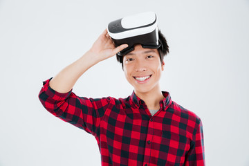 Young asian man wearing virtual reality device