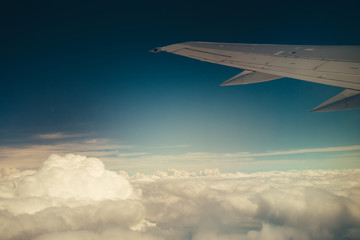 Obraz premium Clouds and sky through window of an aircraft.