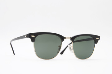Retro black sunglasses side view . Isolated on a white backgroun