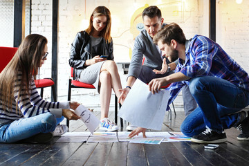 Team job. Photo young businessmans crew working with new startup project in modern loft.