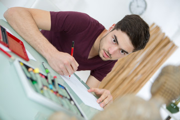 young man drawing pictures in studio