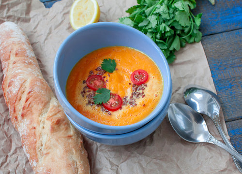 Vegan orange vegetable soup (carrots, sweet potatoes, pumpkin) with herbs and coconut cream.  Perfect for the detox diet or just a healthy meal.  Love for a healthy raw food concept.