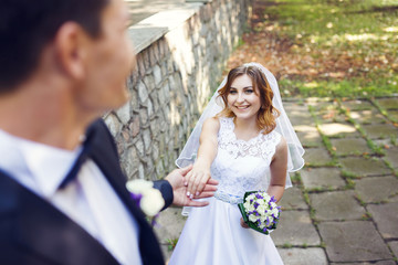 Happy wedding couple in a park