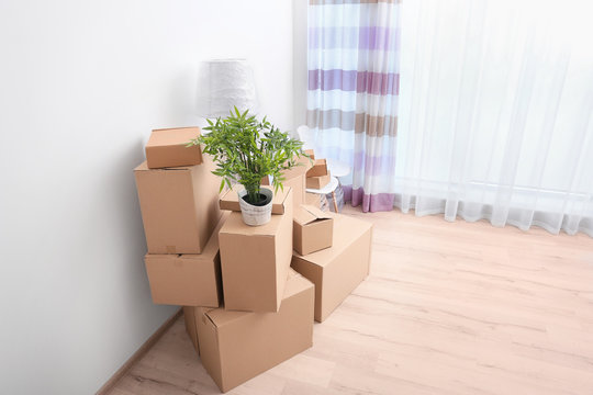 House moving concept. Boxes in new room