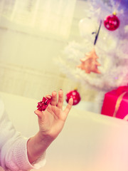 Fototapeta na wymiar Female hand preparing gifts for Christmas