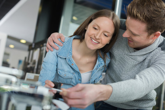 young couple fixing a devise at home