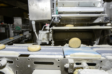 Bread dough running on conveyor belt
