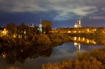 Fototapeta na wymiar Сity landscape with river by light of evening lamps.