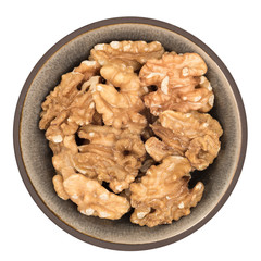 Organic walnuts in ceramic bowl isolated on white background, top view