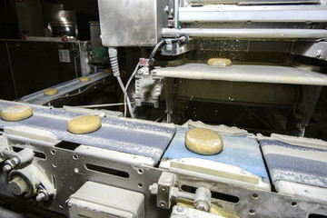 Bread dough running on conveyor belt