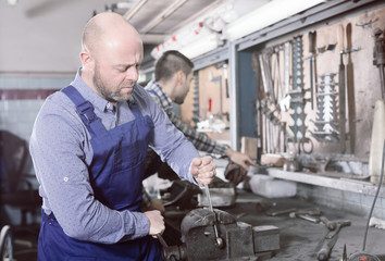 Fototapeta na wymiar Mechanics working at workshop