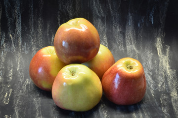 Apple isolated on rustic black background. Organic food.