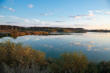 Pond in countryside in autumn at sunset