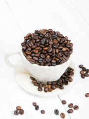 coffee beans cup on white wooden background