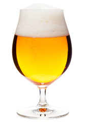 Full snifter glass of pale lager of pilsner beer with a large head of foam isolated on white background