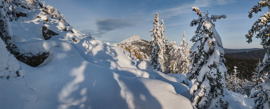 Fototapeta idillic mountain winter landscape with snow drifts and snowcovered trees