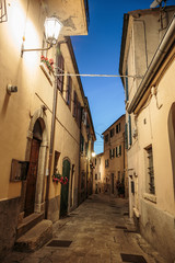 Narrow street in the old town in Italy at night