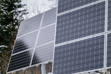 Solar panel plant in cloudy weather in the winter forest