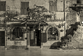 Entrance of the old village house decorated with flowers at nigh