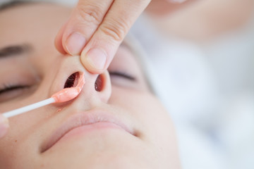 Nose waxing.Nose hair removal with hot wax