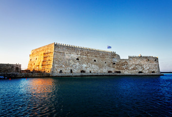 Fototapeta premium Heraklion old venetian bay with old venetian fort and boat, Crete, Greece, retro toned