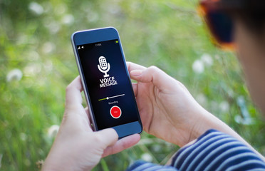 woman in the grass recording voice message
