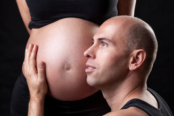 Portrait of delighted father expecting a baby